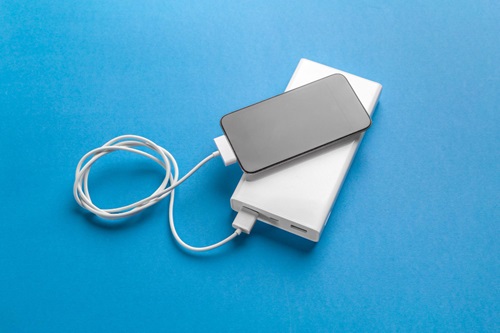 Portable power bank charging smartphone. Source: https://freepik.com